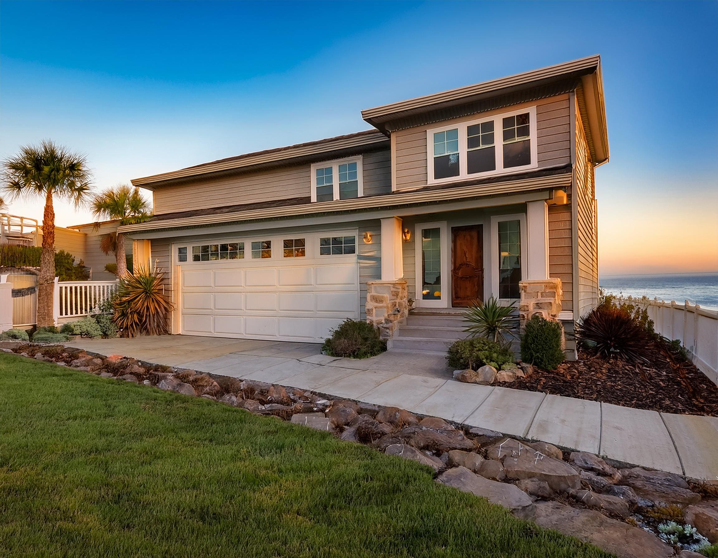 A home exterior with newly installed fiber cement siding in a light neutral color. J Kidd Construction